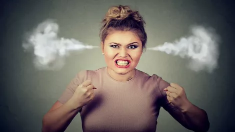 Angry woman blowing steam
